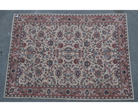 A vintage 20th century Kashmar Persian rug, featuring a cream central field, with red and blue floral motifs and patterns, an