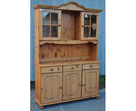Country pine Victorian revival Welsh dresser comprising base with a series of short drawers and cupoards. Above, a central sh