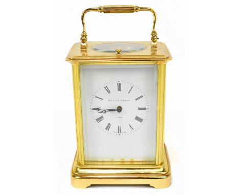 MATTHEW NORMAN; a gilt brass repeating carriage clock, the enamelled dial set with Roman numerals on bracket feet, height inc