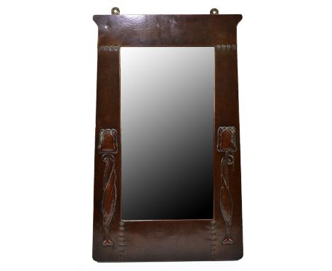 LIBERTY &amp; CO; An Arts &amp; Crafts sheet copper wall mirror, with embossed floral motifs and planished decoration, 64 x 3