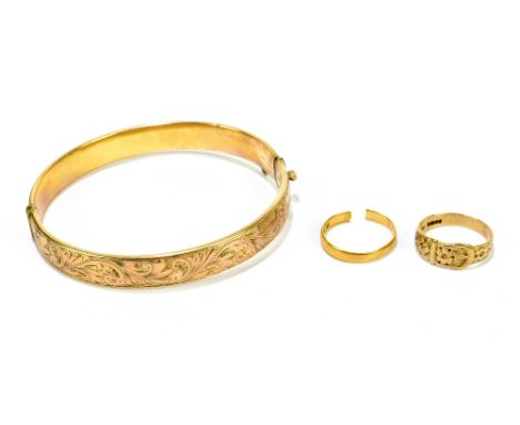 A 22ct yellow gold wedding band, cut, 2.33g, a 9ct yellow gold buckle ring, 2.8g, and a 9ct gold and metal hinge snap bangle,