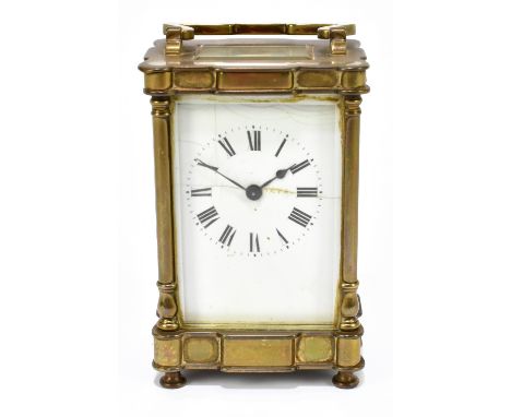 A late 19th century French brass cased carriage clock, the enamelled dial set with Roman numerals, height including swing han