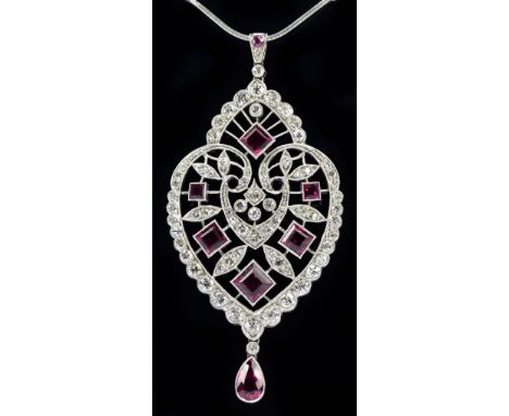 A fine platinum Art Deco inspired diamond and ruby set pendant, the filigree frame set with sixty-nine brilliant cut diamonds