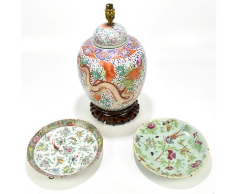 An early 20th century Chinese Famille Verte ginger jar and cover decorated with a five claw dragon with lotus flowers and aus