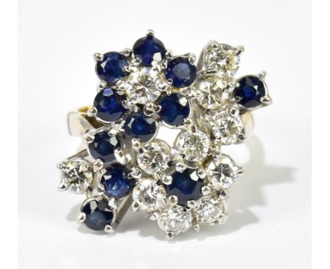 A yellow and white metal diamond and sapphire floral spray ring set with eleven round brilliant cut diamonds and eleven round