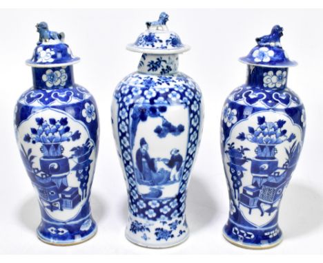 A pair of late 19th century Chinese blue and white porcelain temple jars and covers decorated with objects and prunus flowers