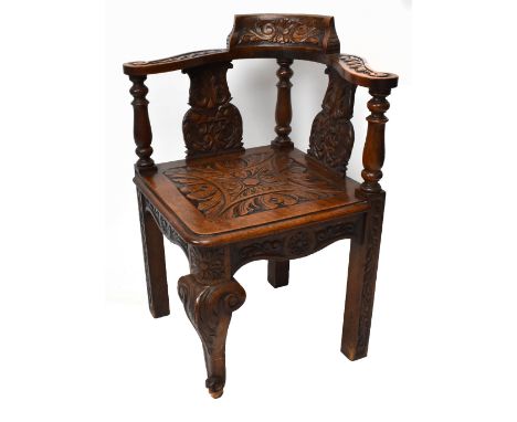 A late Victorian 18th century style carved oak corner chair, with solid seat, on cabriole front legs, height 79.5.&nbsp;Addit