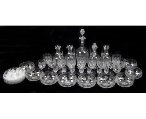 A suite of Edwardian glassware with engraved floral decoration including finger bowls, a decanter, four water jugs, assorted 