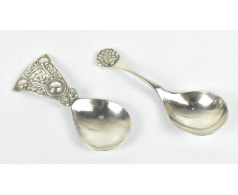 SHIPTON &amp; CO; a hallmarked silver Celtic caddy spoon, Chester 1935, with a further caddy spoon with flower head terminal,