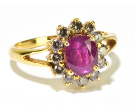 A yellow metal diamond and ruby flower head ring, the ruby weighing 2.13ct within a border of diamonds totalling 0.68ct, size