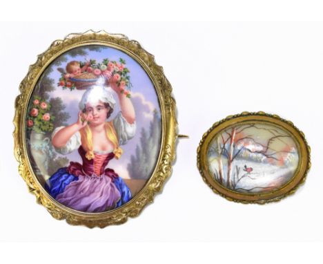 A Swiss yellow metal and painted enamel oval brooch decorated with a young woman in landscape holding a basket upon her head,