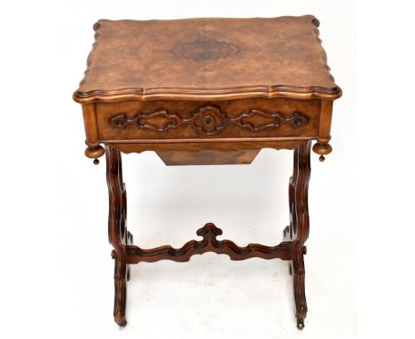 A circa 1860 French figured walnut sewing table with mirrored sectioned interior, sliding basket, fret applied detail to the 