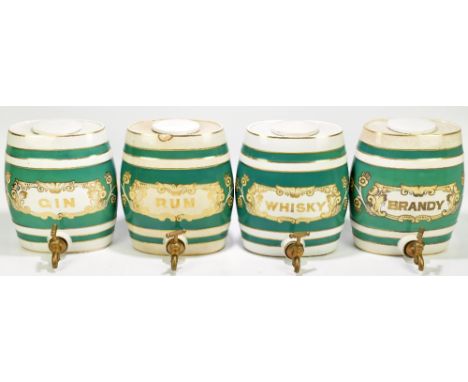 A set of four early 20th century ceramic spirit barrels with brass taps inscribed 'Brandy, Whisky, Rum and Gin', heights 30cm