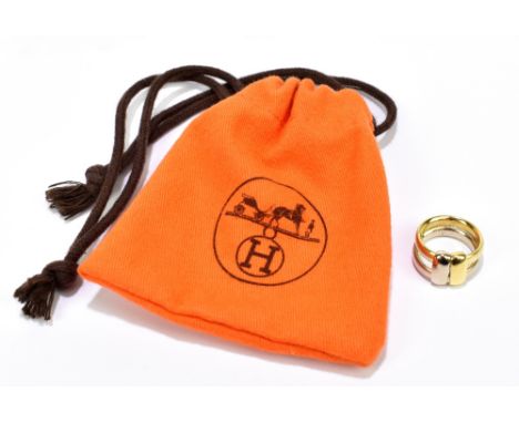 HERMÈS; an 18ct yellow gold signed Hermès ring made up of two bands held together by two moving smaller bands that lie flush,