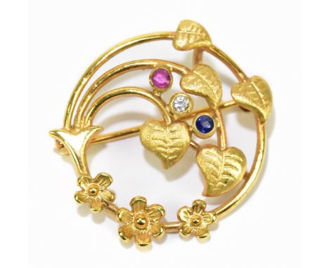 A German yellow metal diamond, ruby and sapphire set pierced leaf decorated brooch, diameter 26mm, approx 2.5g.