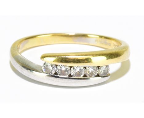 An 18ct yellow and white gold five stone diamond crossover ring, size O, gross weight 3.7g.&nbsp;