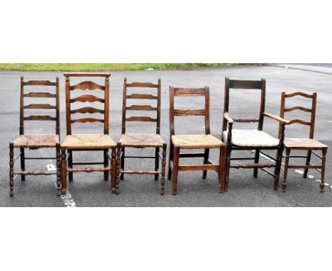 A late 18th century elm ladder back rush seated dining chair, together with an elm framed rush seated open sided armchair, a 