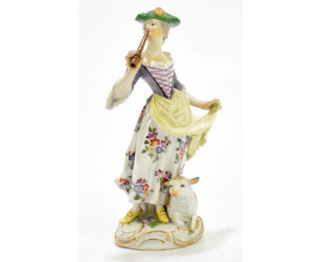 MEISSEN; a 19th century hard paste porcelain figure of a lady wearing a hat playing the flute, with a lamb at her feet, blue 