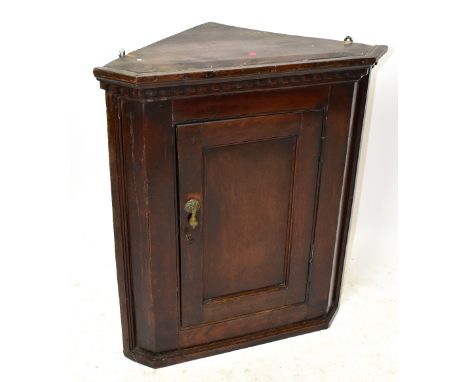 An 18th century oak hanging corner cupboard with single panelled door, height 70cm, width 60cm, depth 35cm.Additional Informa