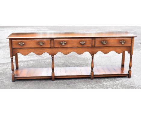 A reproduction oak dresser, of 18th century design, with three drawers and pot shelf base, height 76cm, width 212cm, depth 45