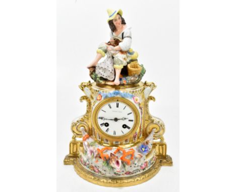 A late 19th century French hard paste porcelain figural mantel clock, modelled with a seated male wearing a yellow cap mendin