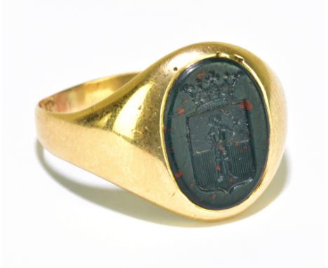 A gentleman's yellow metal signet ring, set with a bloodstone, with intaglio crest, size R, gross weight 5.5g.&nbsp;Additiona