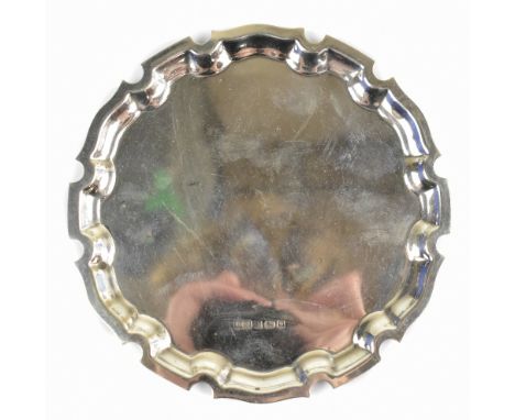 A hallmarked silver waiter, with shaped rim, Birmingham 1998, 3.4ozt/108g, diameter 15.5cm (1).  Additional InformationSome g
