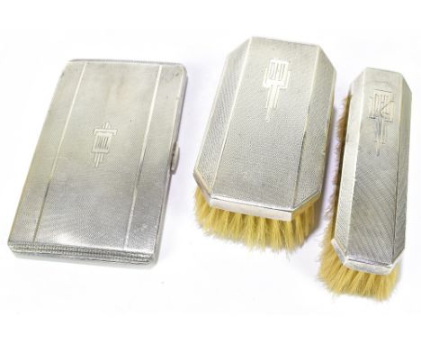 A George V hallmarked silver Art Deco designed cigarette case of rectangular form with engine turned detail and engraved init