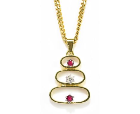 An 18ct yellow gold diamond and ruby three stone pendant suspended on an 18ct yellow gold flat link chain, length of chain 60