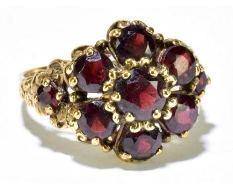 A 9ct yellow gold and garnet set floral ring, size P 1/2, approx 5.6g.