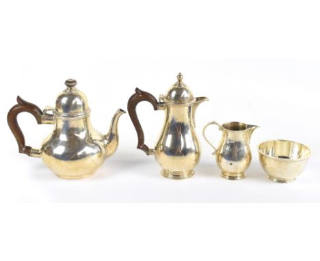 GOLDSMITHS &amp; SILVERSMITHS CO; a George V hallmarked silver four piece tea service of plain baluster form, London 1934/35,