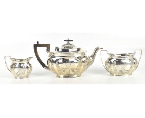 MARK WILLIS; a late Victorian hallmarked silver three piece tea service with gadrooned lower decoration and panelled bodies w