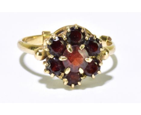 A 9ct garnet floral cluster ring, size N (with internal ring clip), approx 2.8g.