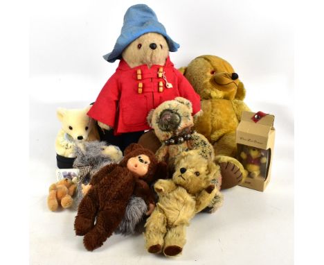 PADDINGTON BEAR; a soft toy with red felt coat and blue Dunlop wellington boots, height 43cm, with a small Steiff Winnie the 