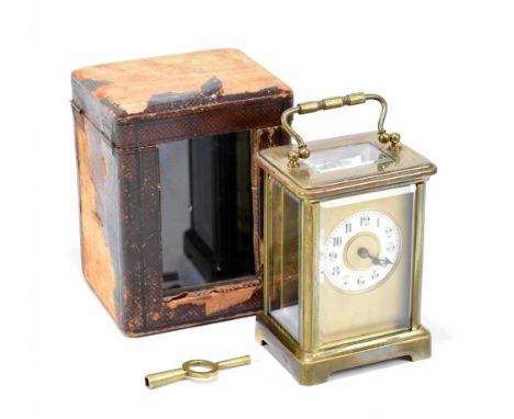 An early 20th century French brass carriage timepiece, with enamel Arabic numeral chapter ring, with leather case, height of 