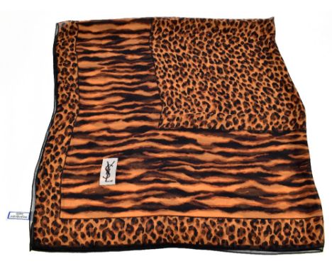 YVES SAINT LAURENT; a 100% silk leopard print large scarf with YSL logo to front, 140 x 140cm.Additional InformationThe scarf