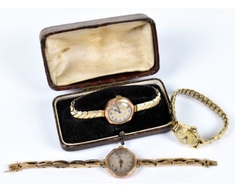 Two lady's 9ct gold wristwatches, each with Arabic numeral dials and plated straps, with a Timex gilt metal watch (3).&nbsp;A