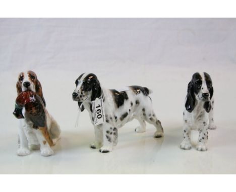 Three Royal Doulton ceramic models of Working Cocker Spaniels, one seated with Pheasant in mouth, models HN1109 &amp; HN1028