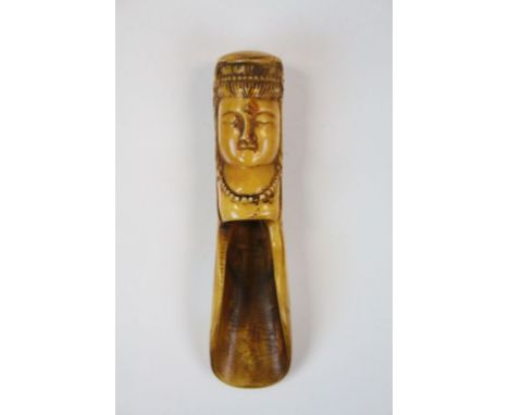 Bone tea caddy spoon, the terminal modelled as a sleeping deity