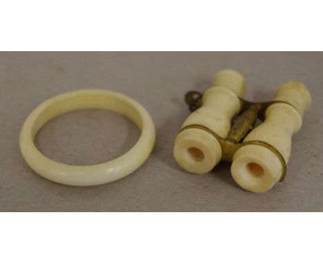 Antique ivory miniature binocular form Stanhope with viewing scene intact; together with an ivory ring. Export of these items