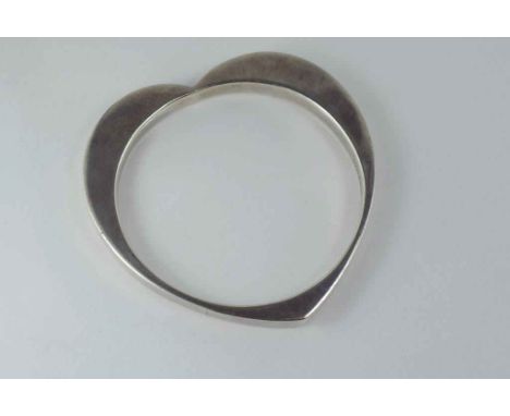 A sterling silver bangle with heart shaped exterior