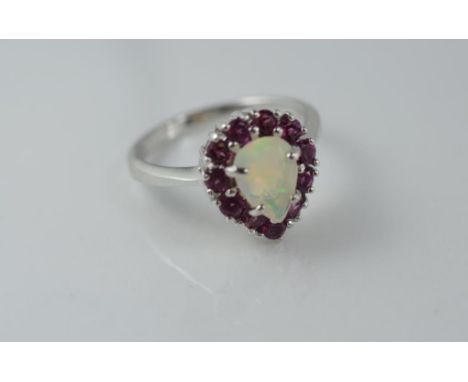 A silver, ruby and solid opal ring size P/8