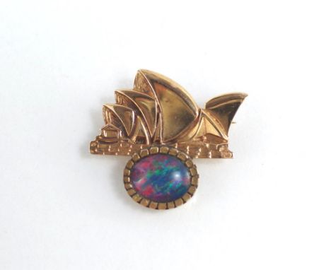 A  gold opera house shaped brooch set with opal, in 9ct gold, weighing approx 4.8 grams