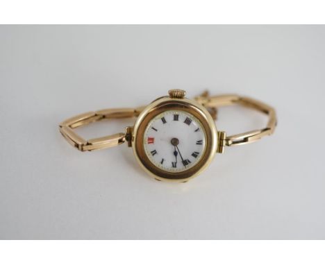 A ladies 9ct gold wristwatch with enamel dial and gold band, all 9ct, not working when tested, total weight approx 18.45 gram