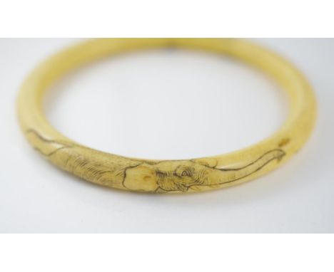 A good antique Chinese ivory bangle engraved with elephants, internal diameter approx 7.5cm, provenance from a private collec