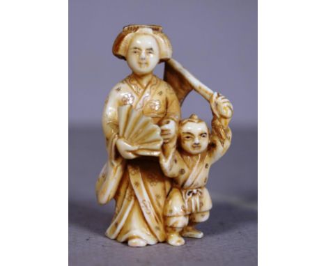 Antique Japanese carved ivory okimono figure standing woman with child, signed to base. Export of this item is not permitted.