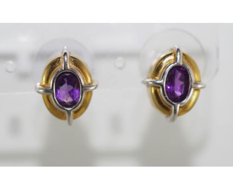 A pair of two tone gold and amethyst earrings weighing approx 4 grams, marks on the post