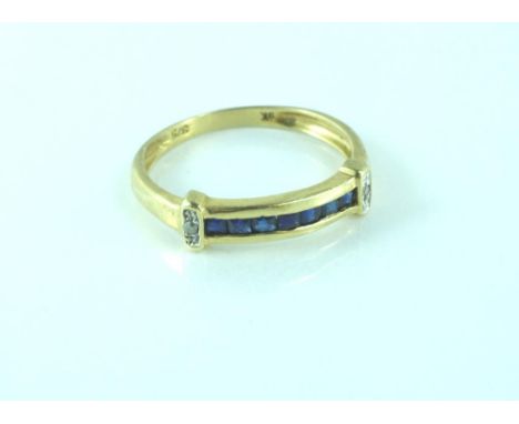 Yellow gold sapphire and diamond dress ring set in 9ct gold, centre line of channel set sapphires with diamonds on either sho