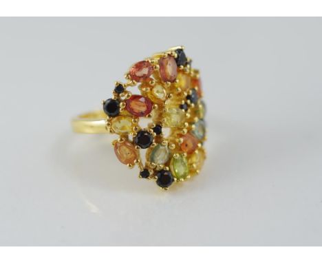 A silver gilt and multi-coloured sapphire ring size N1/2 / 7