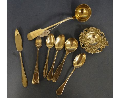 Eight various pieces continental silver cutlery including pair ice cube tongs; ladle; four various spoons; a butter knife; an